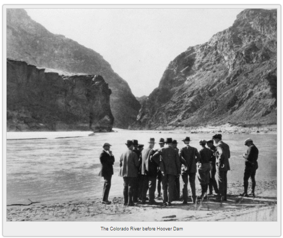 men in suits and hats in 1922 standing in the location of the future hoover dam